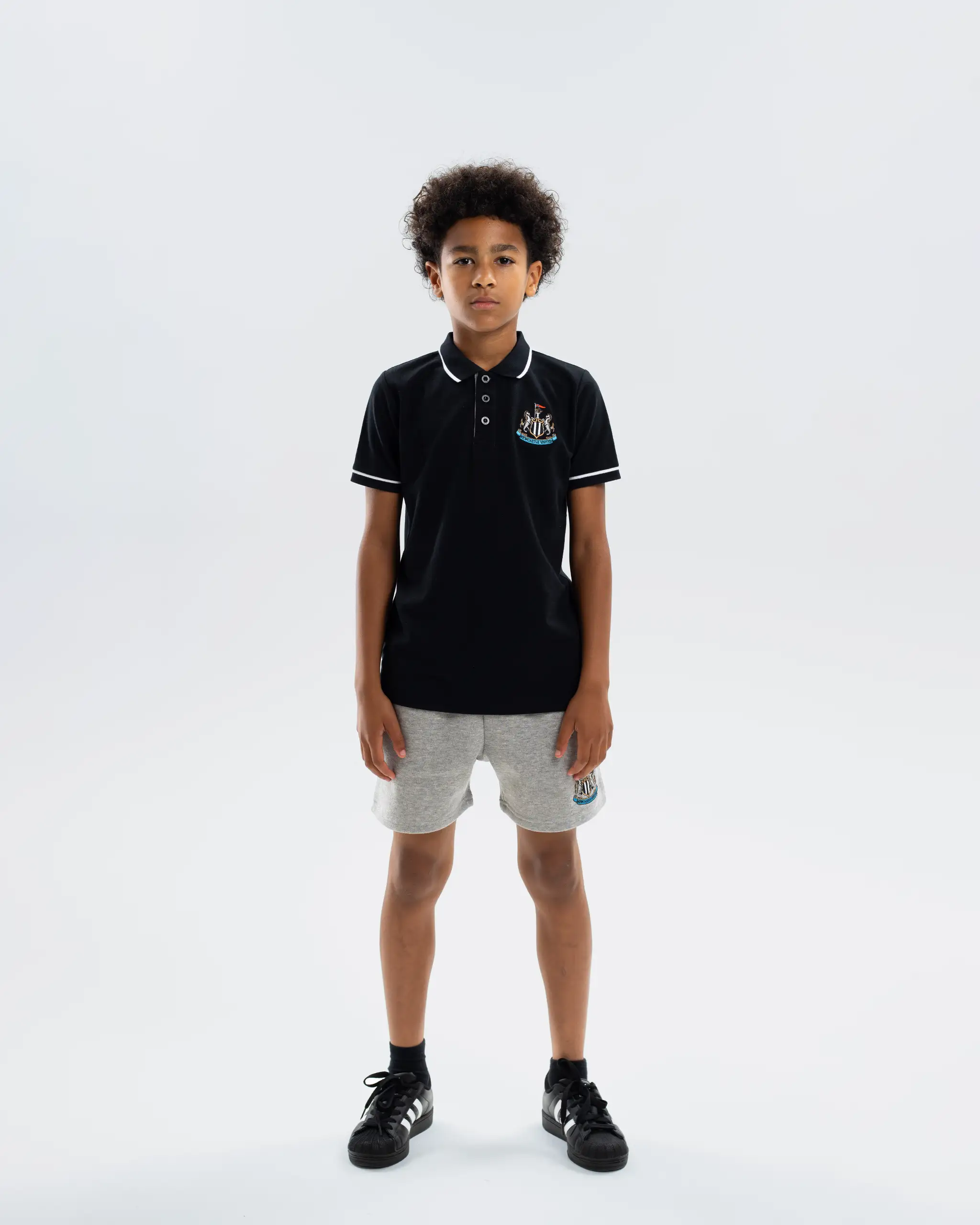 Newcastle United Kids' Essentials Range Black Polo Shirt